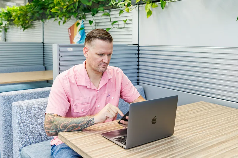 Wesley Cable, founder of PipelineOS, working on a client website at his laptop